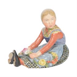 Royal Copenhagen figure, Jutland girl, designed by Carl Martin Hansen, from the Danish National Costumes series, of a girl with a flower garland, marked beneath, H8cm 