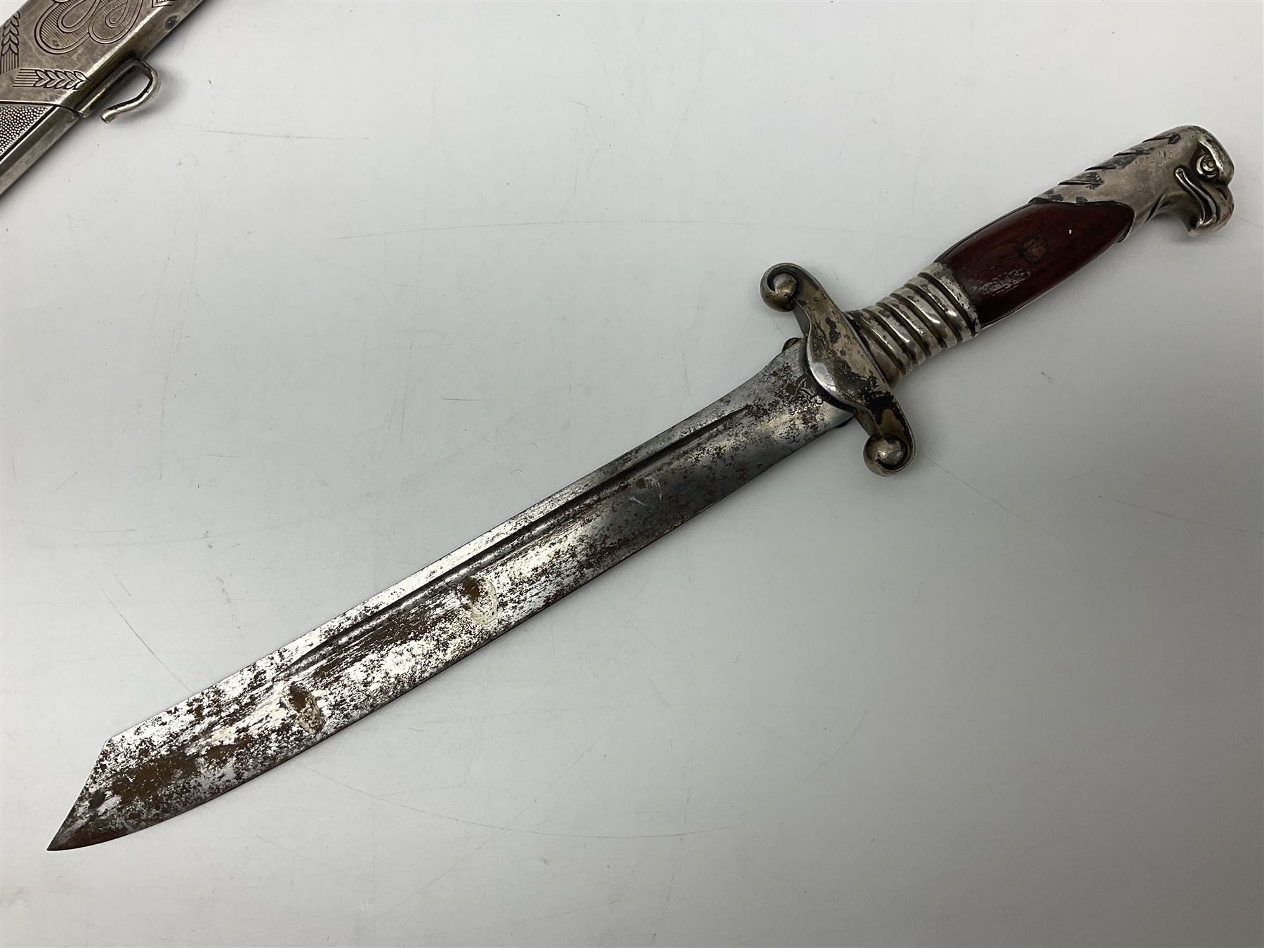 WW2 German RAD (Reichsarbeitdienst) Leader's hewer dagger,  the 25.5cm fullered steel blade engraved Arbeit Adelt (Work Enables) with Eickhorn squirrel maker's mark; scrolling cross-piece, mahogany grip and eagle pommel; in decorative plated scabbard L40cm overall.