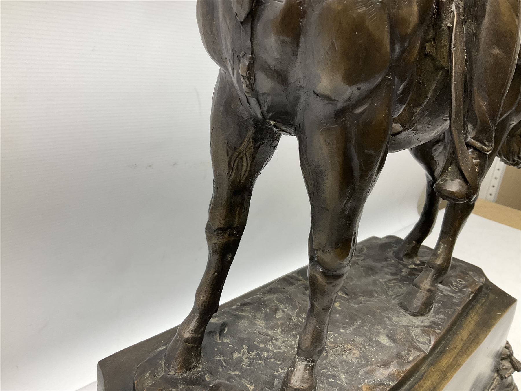 Large and impressive bronze figure of Wellington seated on a horse, on a sarcophogus shaped stepped base impressed 'Meunier Paris', the canted corners inset with battle trophies H68cm L50cm D22cm