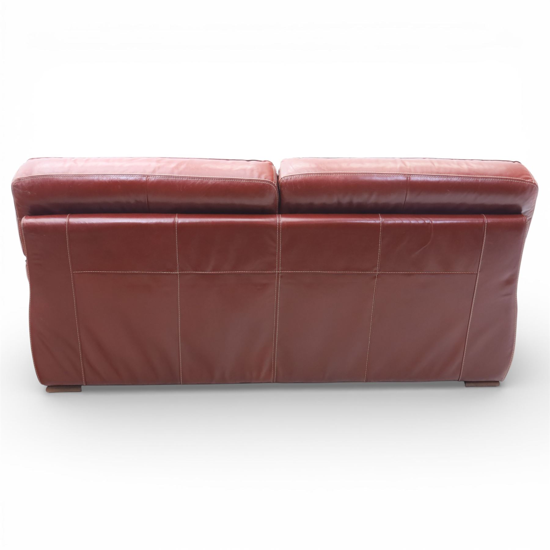 Fabrizio Mantellassi - 20th century Italian red leather suite, one three seat and two large armchairs, upholstered in deep red hide with stitched seam detailing, with magazine pockets to each side, the rectangular back cushions above broad padded arms and seat cushions, raised on low block bases

Sofa: H c98m, W 203cm, D 92cm
Armchair: H 98cm, W 113cm, D 92cm