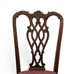 Chippendale design set of ten (8+2) mahogany dining chairs, serpentine cresting rails with carved detail over pierced ribbon-tied splats, red damask upholstered drop-in seats, on cabriole supports with acanthus carved knees and claw and ball feet