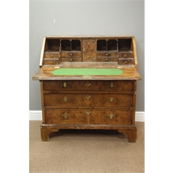  Early to mid 18th century walnut bureau, sectional figured veneers with walnut stringing, stepped fitted interior with cupboard, two short and three long graduating drawers, on bracket feet, sides banded, W95cm, H102cm, D51cm  