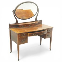 Edwardian mahogany dressing table, rectangular top above a central kneehole drawer flanked by two short drawers over two graduated drawers to each pedestal, raised superstructure with three small drawers and oval swing mirror on shaped supports, on square tapering legs with castors
