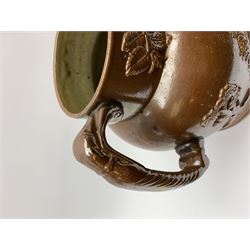 19th century salt glazed stoneware jug, with mask spout and greyhound modelled handle, the body decorated in relief with Royal Coat of Arms flanked by lions, the rim with the flowers of the union, roses, thistles and shamrocks, H26.5cm