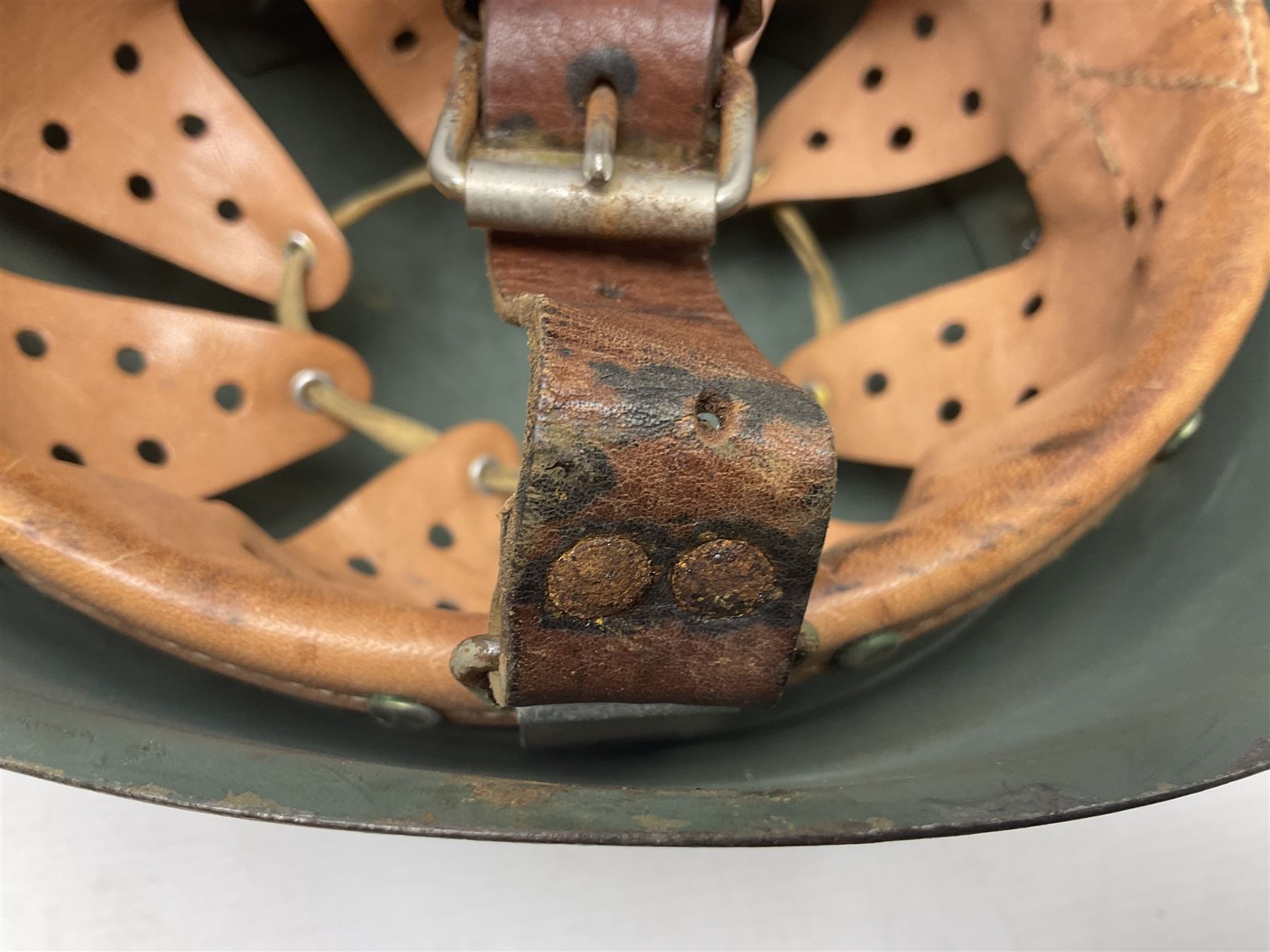1960s Italian parachutist helmet with liner; camouflage paintwork with parachutist crest to the front