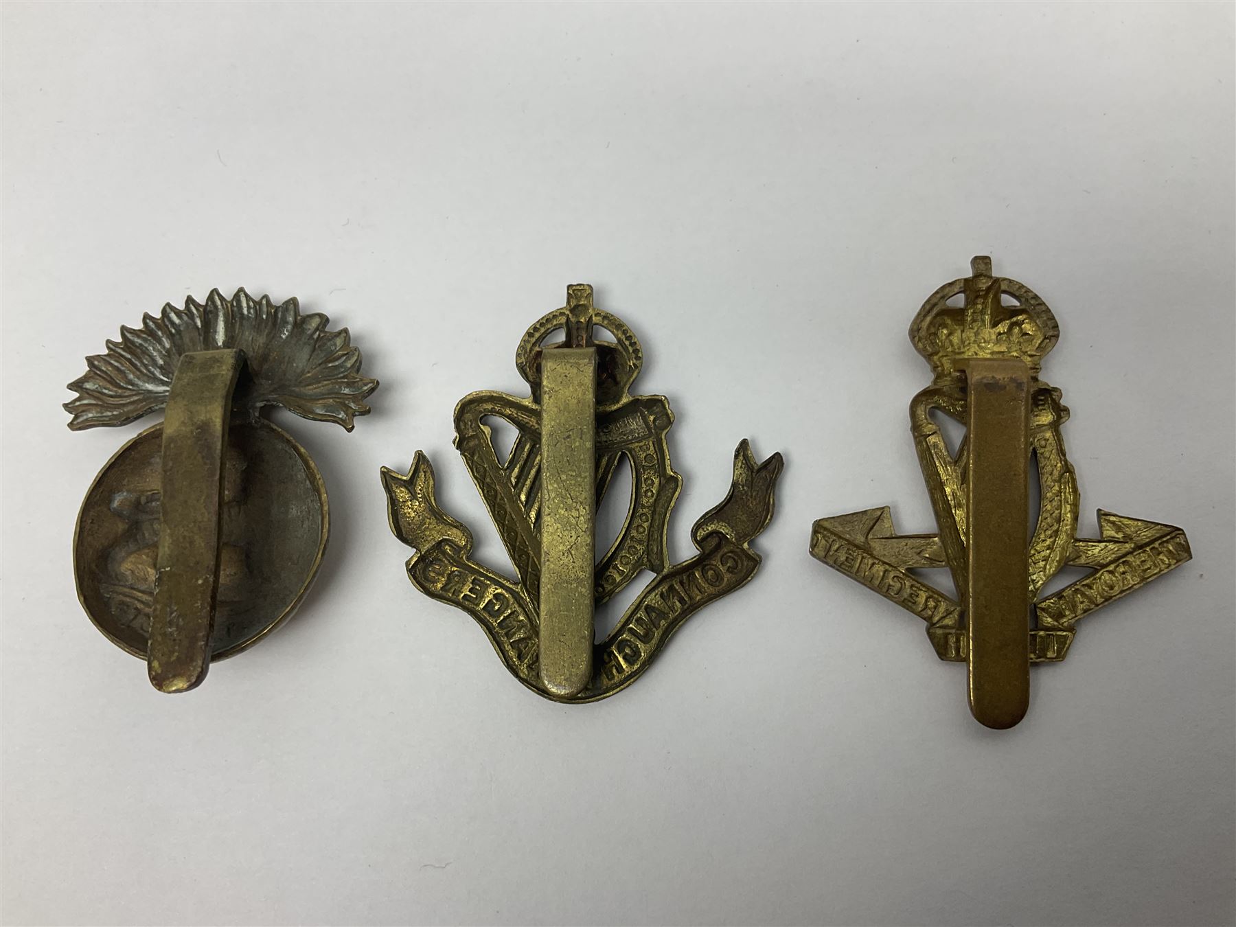 Fourteen cap badges of Irish interest including Royal Dublin Fusiliers inscribed to the slider 'From A. O'Connor 2nd Batt. Dec.2nd 1915', Connaught Rangers, South irish Horse Yeomanry, Inniskilling Fusiliers, Royal Irish Regiment etc; and seven Welsh badges including South Wales Borderers, Welsh Guards, 3rd Bn. Monmouthshire Regt. etc (21)