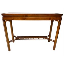 Wade - yew wood console table, rectangular top with canted corners and raised lipped edge, on chamfered square supports united by narrow under-tier