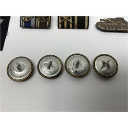 Collection of eleven German metal and cloth badges and uniform buttons including driver's badge, two 'SS' fabric skulls, private's shoulder tabs, Police cloth badge, tank destruction badge, medal bars and ribbon etc; most WW2 period