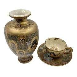Japanese Satsuma vases decorated with immorals, together with a matching teacup and saucer, with painted mark beneath, vase H19cm 