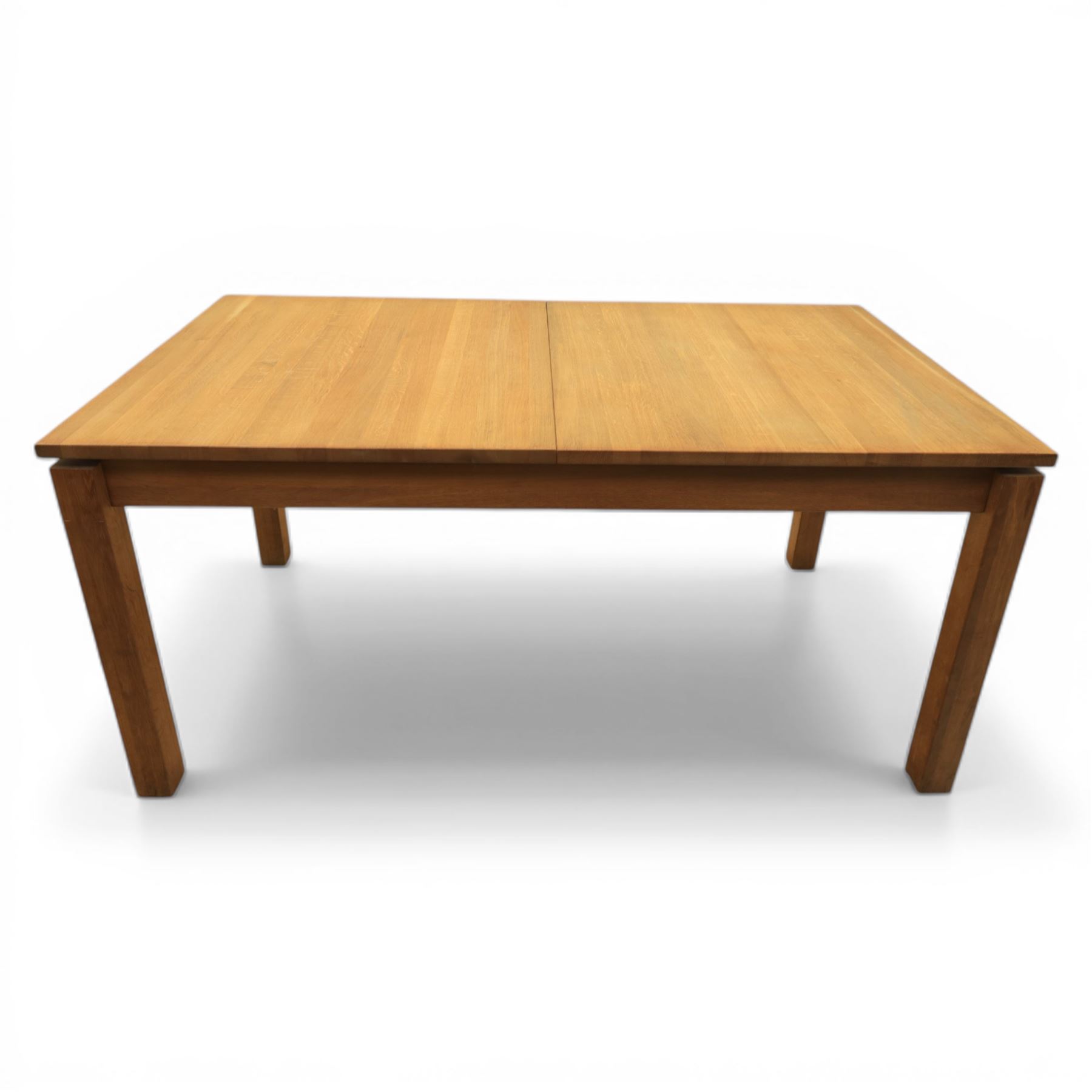 Contemporary teak dining suite comprising extending table and eight chairs, the table with rectangular plank top and one additional leaf extending to 210cm, supported on square tapering legs, the chairs with tall slatted backs and cream upholstered seats