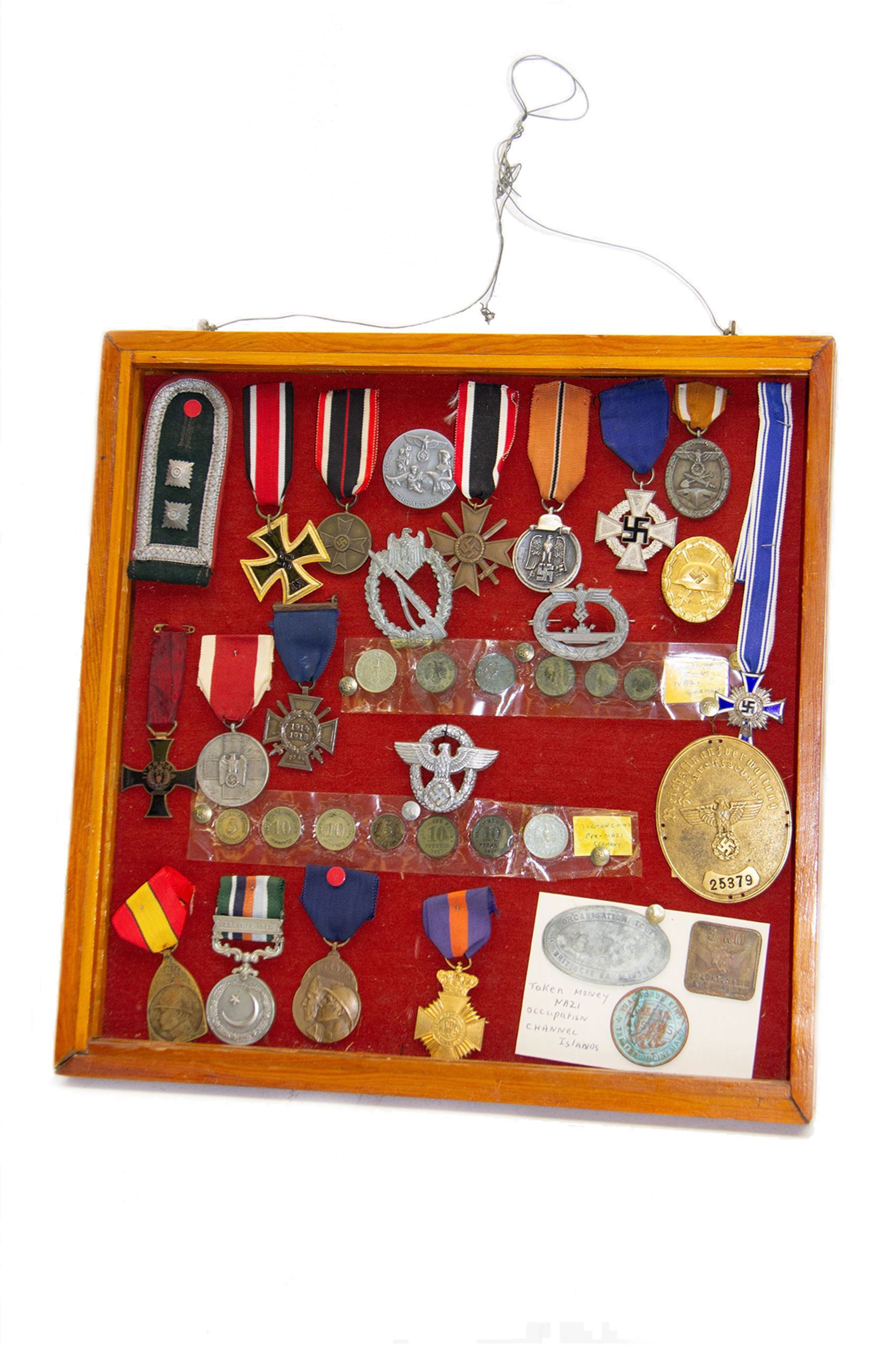 European and World medals and replicas, Italian Commemorative Cross of the 11th Army, German Cross of Honor, Pakistan 1948 general service medal, Belgium Commemorative medal, together with German coins, badges etc, all within a framed display, H29cm, W38cm 