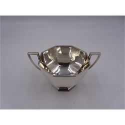 Early 20th century silver porridge bowl, of faceted octagonal form, wit angular twin handles and upon conforming stepped foot, hallmarked Skinner & Co, London 1913