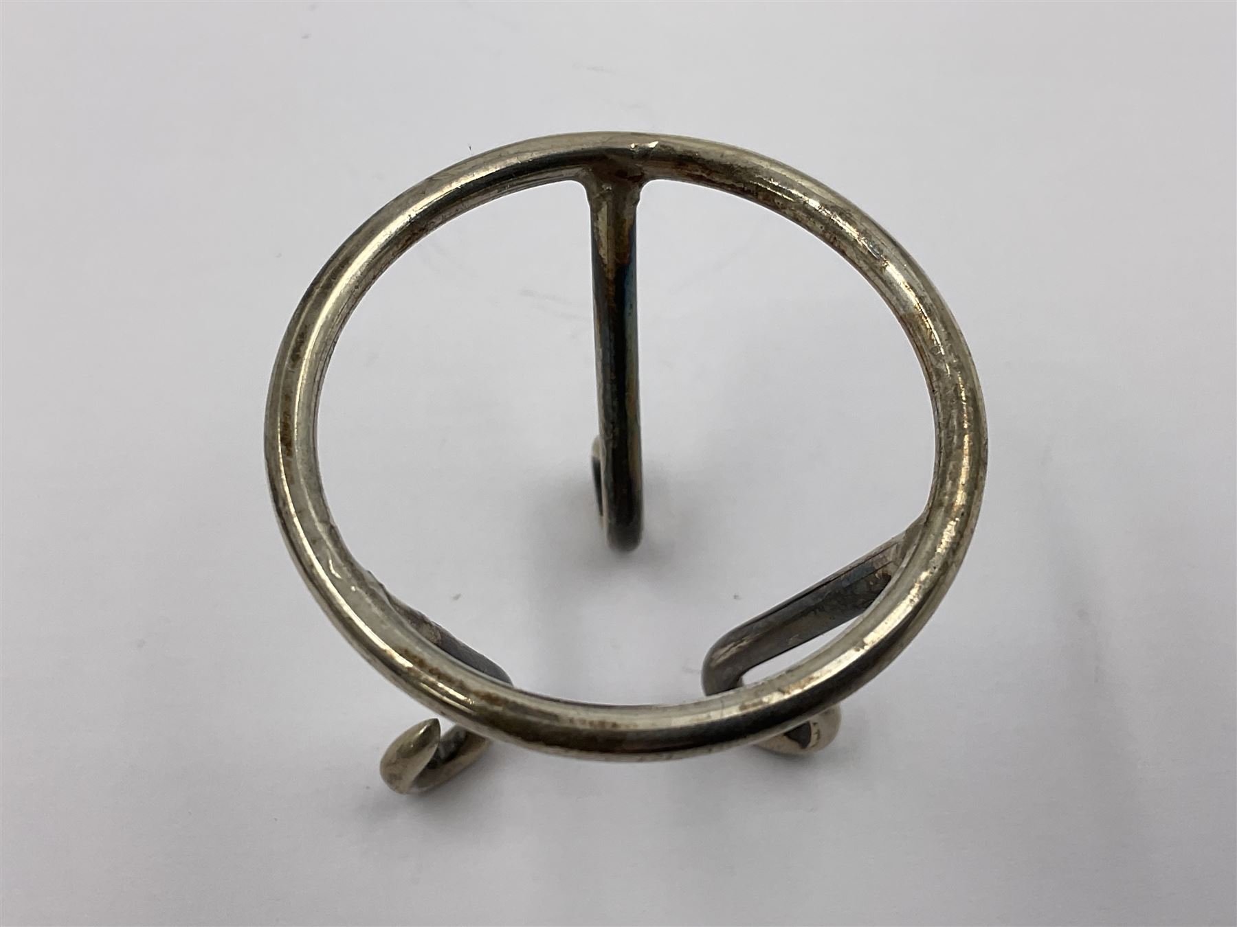 Modern silver limited edition Easter egg, no. 70/500, the gilt openwork body decorated with cascading bluebells and hinged cover with pierced circular panel set with a single faceted purple stone, opening to reveal a gilt interior, upon silver stand with three scrolling pad feet, each hallmarked St James House Company, London 1981, height including stand 8cm