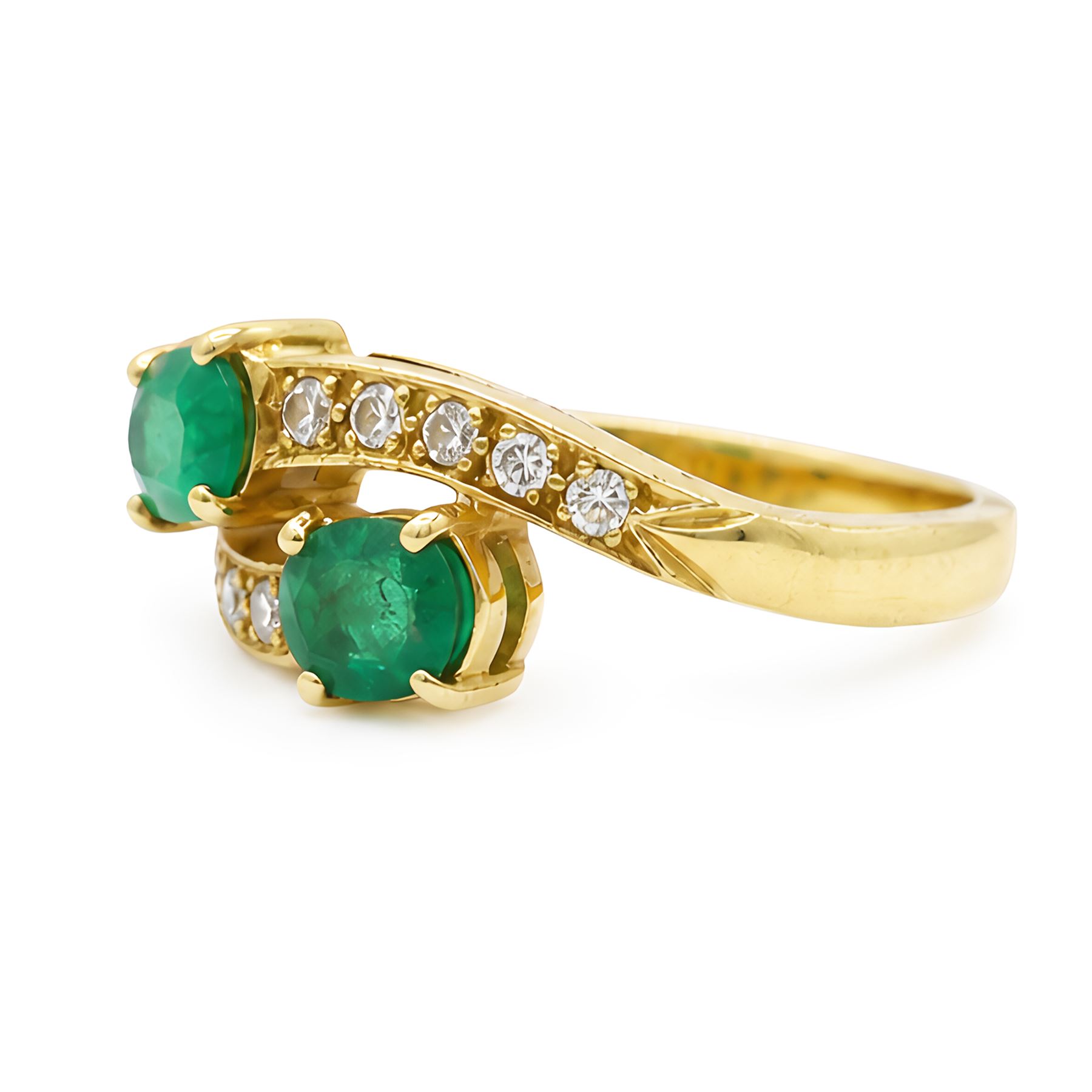18ct gold emerald and diamond crossover ring, set with five round brilliant cut diamonds and two oval cut emerald finials, Sheffield 1989, total emerald weight approx 0.40 carat