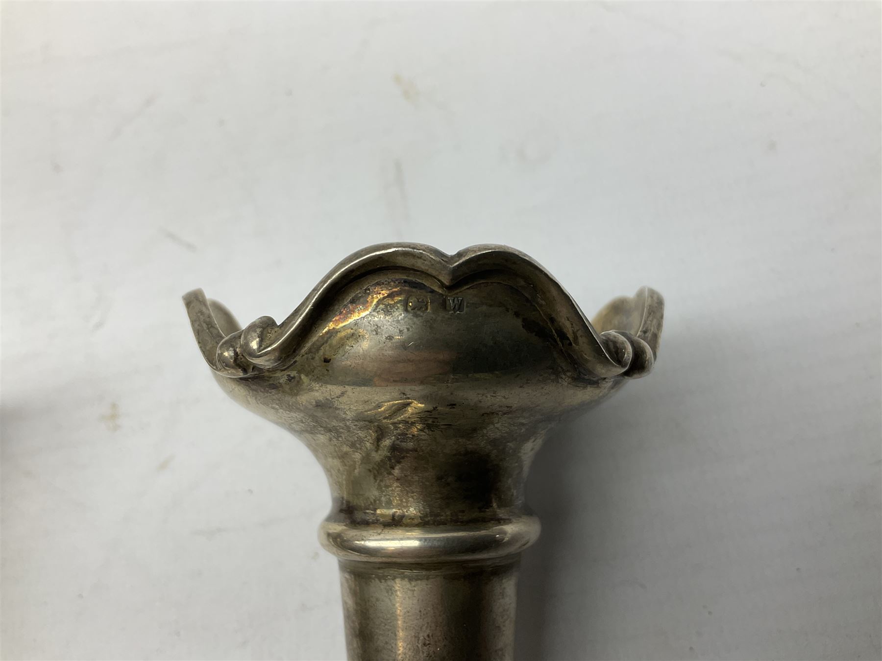 Four hallmarked silver trumpet vases, total weight 108g, upon silver plated stand with foliate decoration and bun feet