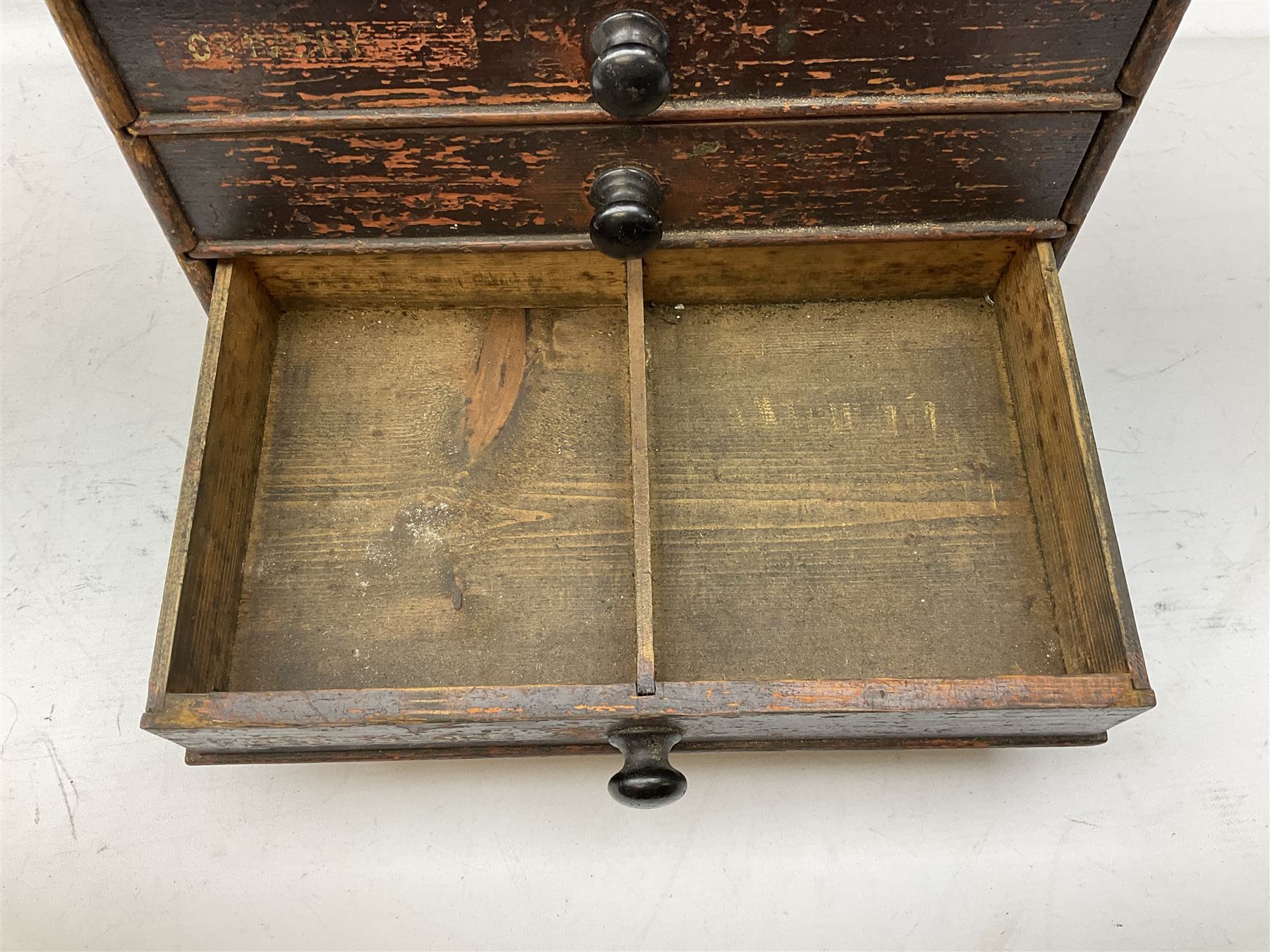 Early 20th Century Dewhurst table top chest, decorated with gilded 'Dewhurst's Sylko Machine Twist Strong Lustrous' lettering above six long drawers with names and numbers of cotton also detailed in gilt, H39cm