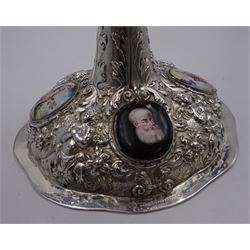 German silver chalice, the bowl, stem and foot each with 19th century repousse and chased decoration depicting putti masks, C scrolls and flowers, set with two hand painted porcelain roundels, possibly Berlin, and six later applied enamel roundels, each depicting religious scenes, the gilded bowl upon knopped stem and spreading octofoil foot, the base with marks for Munich, c.1695 and maker's mark FK