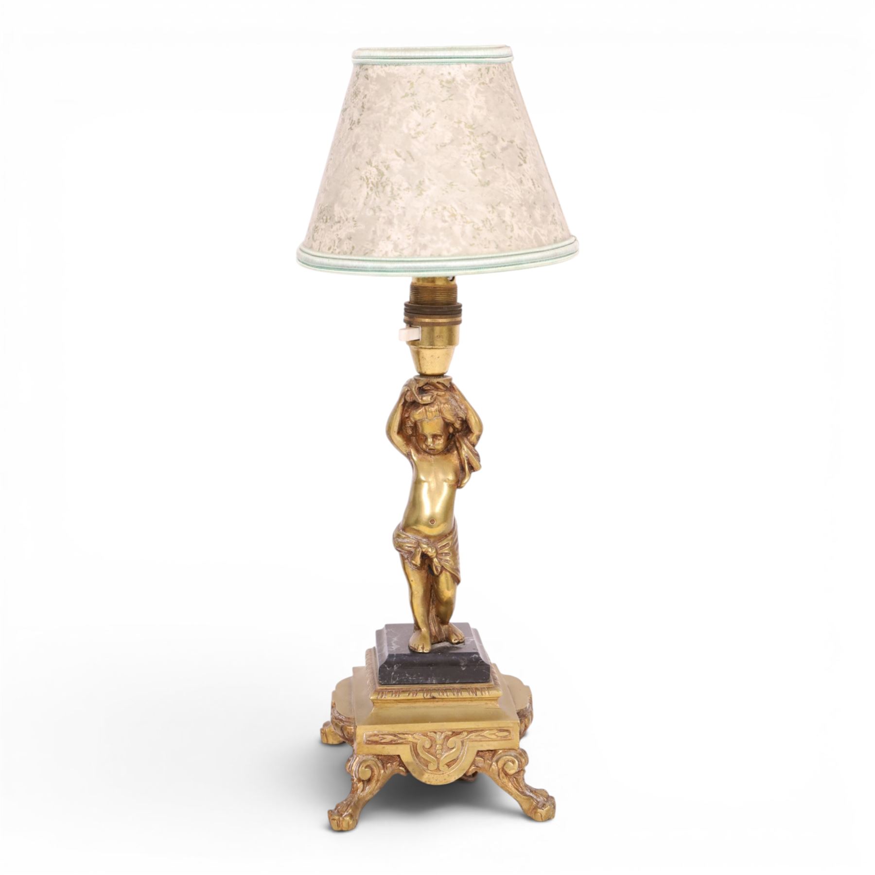 Pair of brass table lamps, the central column modeled as a putti upon a square marble base raised upon four claw feet, H29cm