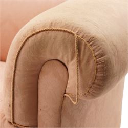 Victorian two seat sofa, upholstered in pink fabric, bowed form with scroll back and arms, raised on turned legs with castors