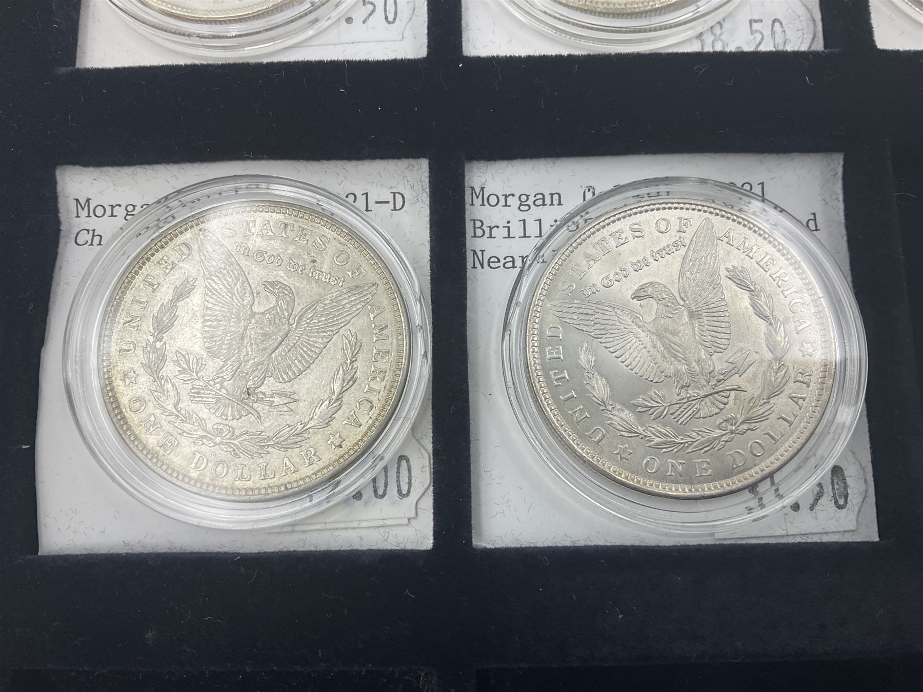 Seven United States of America silver Morgan dollar coins, dated 1884, 1901 O, 1902 O, 1903, 1904 O, 1921 D and 1921
