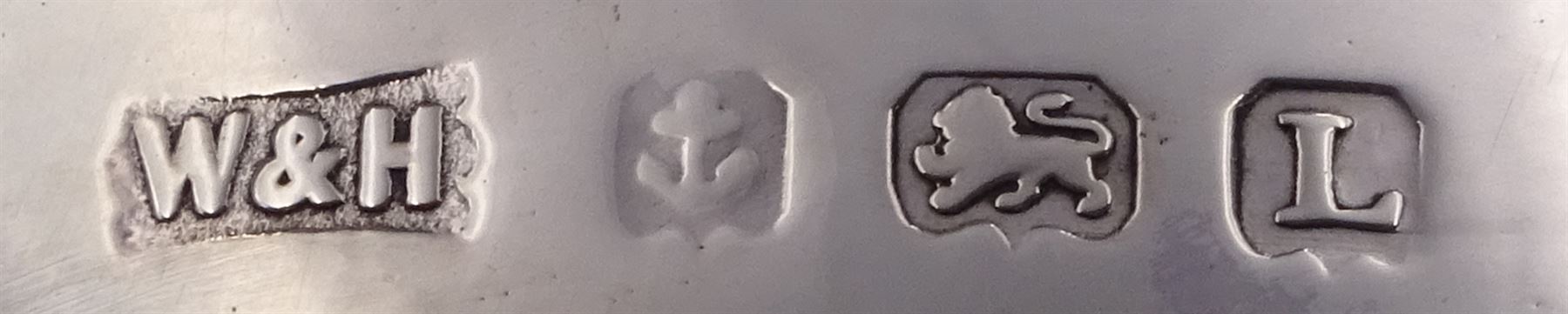 Pair of 1930s silver sauce boats, of typical plain form, each with bead and dart rim and flying scroll handles, upon three pad feet, hallmarked Walker & Hall, Birmingham 1935