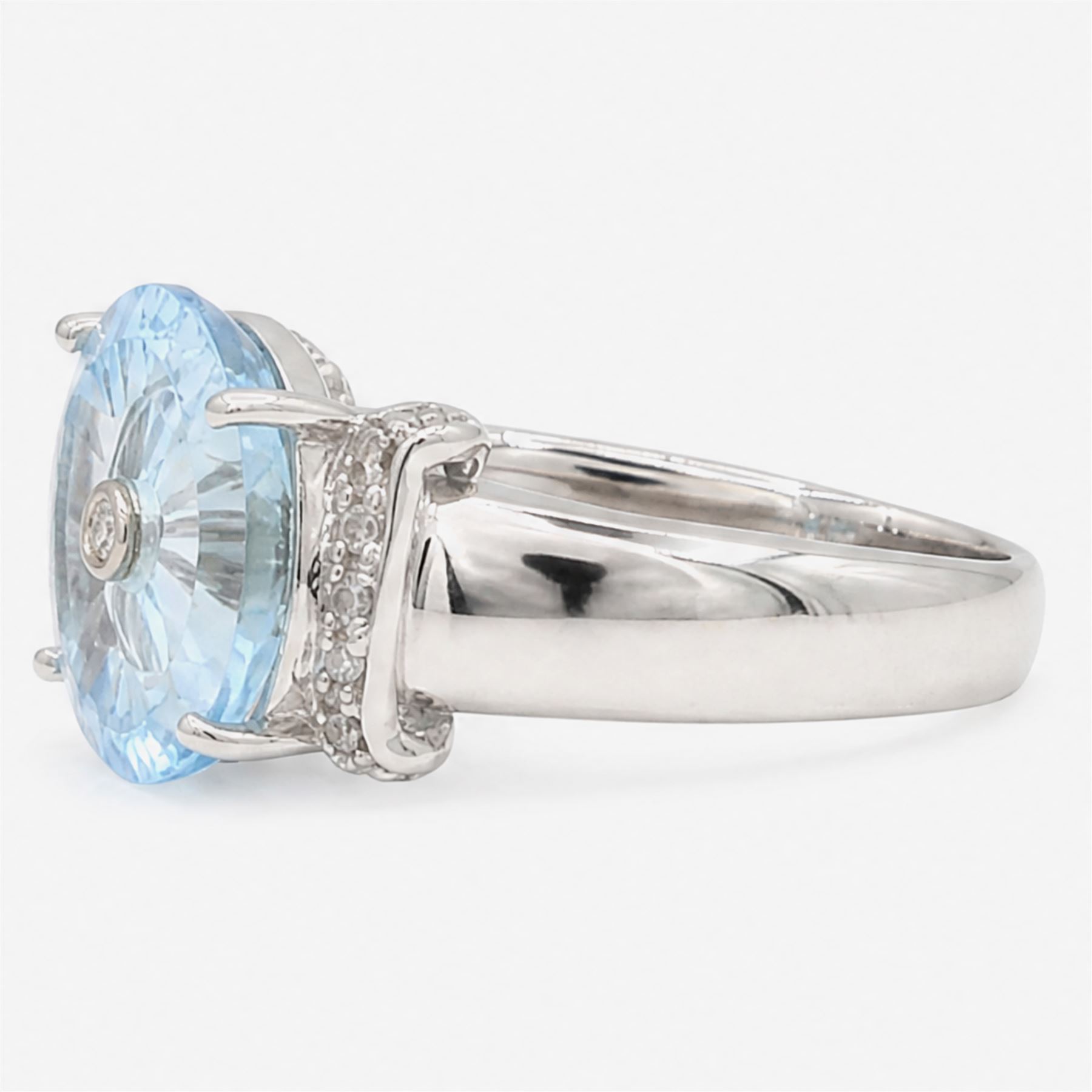 9ct white gold sky blue topaz and diamond Lehrer Torus ring, single round cut topaz of approx 5.20 carat, set with a single round cut diamond, diamond set shoulders and gallery, Birmingham 2012