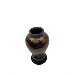 Moorcroft vase of baluster form decorated in the 'Pomegranate' pattern upon dark blue ground with impressed mark, H10cm