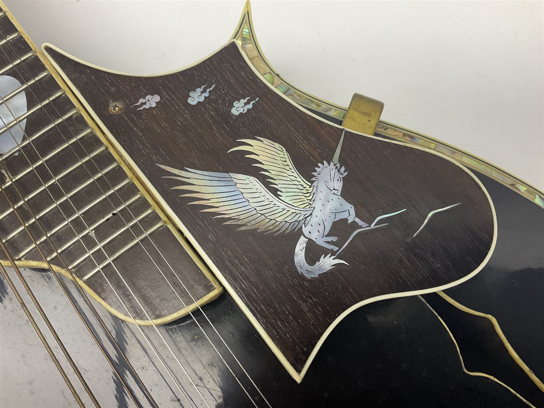 Eastern F-hole eight-string mandolin with black finish and mother-of-pearl inlay of a man riding a winged horse/unicorn amongst clouds and stars with playing card suits to the fingerboard L71cm