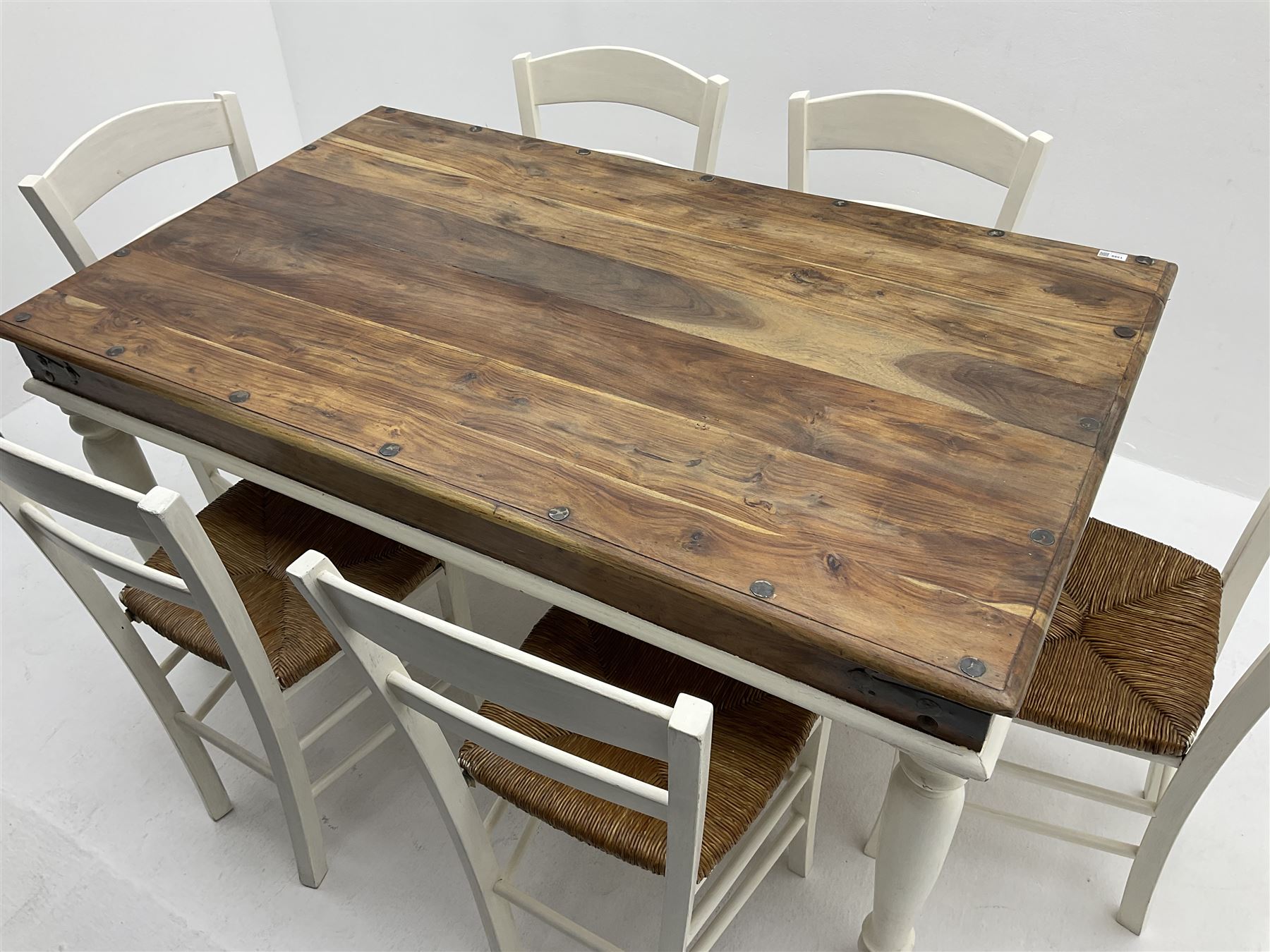 Mexican painted and polished pine rectangular dining table, raised on turned supports (W150cm, D90cm, H76cm), together with six chairs, rush seat raised on square supports (W40cm)