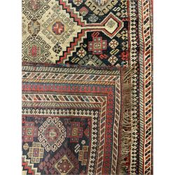 Old Persian Hamadan rug, the indigo ground field with three interlinked lozenge medallions, decorated all over with geometric and stylised motifs, eight band border with repeating geometric patterns 