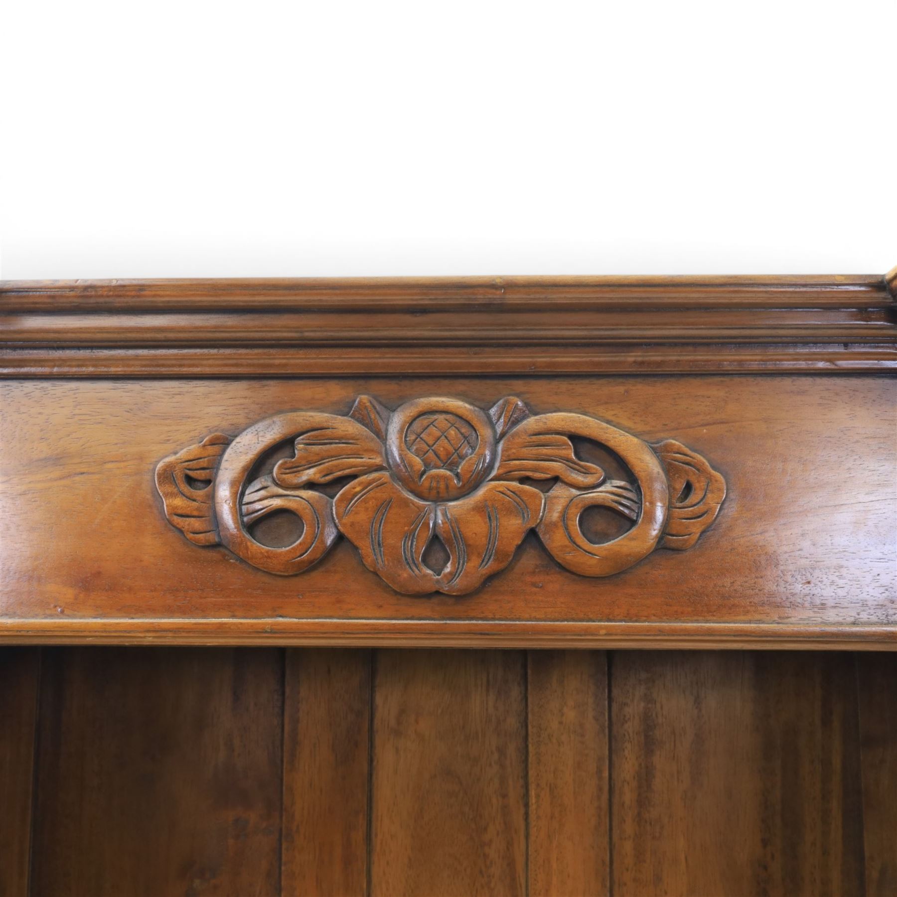 Hardwood open bookcase, fitted with five open shelves, applied carving to top facia