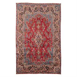 Fine Persian crimson ground Kashan carpet, the busy field with a central floral pole medal...