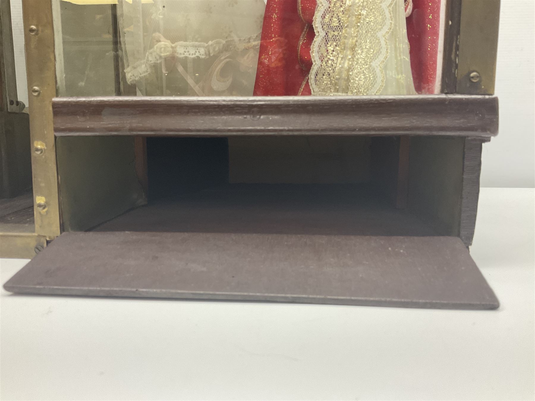 Early 20th century scratch-built wooden hat & gown shop diorama 'Joan', of double-fronted form glazed on three sides with brass and aluminium mounts, rear access apertures and storage under L63cm H45cm D31cm; with small collection of dresses and hats on display stands