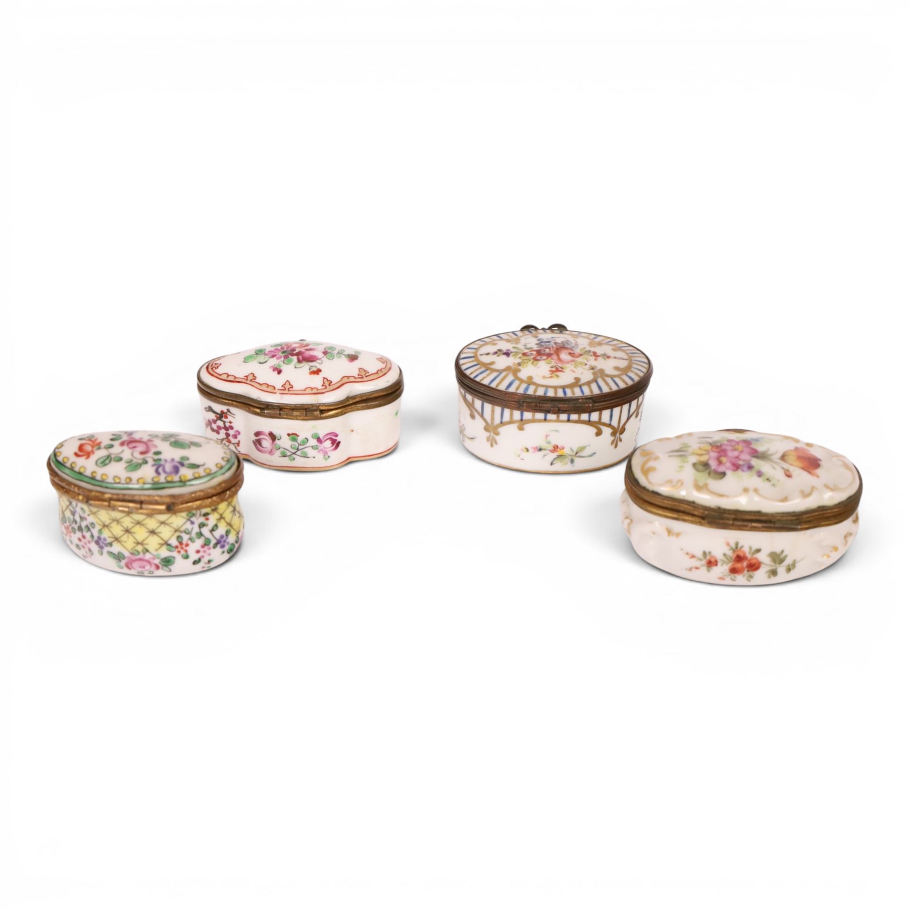 Four 19th century and later pill boxes, each decorated to the lid with floral sprigs, H3cm