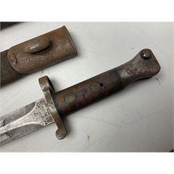 British No 7 MKI knife bayonet with 20cm single edged fullered clipped point blade;  blackened steel, large muzzle ring cross-guard; blackened swivelling pommel marked 'F5H'; red Tufnol composite grips; in blackened steel scabbard L33cm overall; British Pattern 1888 bayonet with scabbard; and German Ersatz bayonet with scabbard (3)