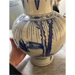 Pair of Chinese Kangxi blue and white porcelain vases, each of baluster form, painted with an outdoor scene containing figures seated upon the ground reading scrolls and holding fans, willow and bamboo tress, rock work and water, H27cm
