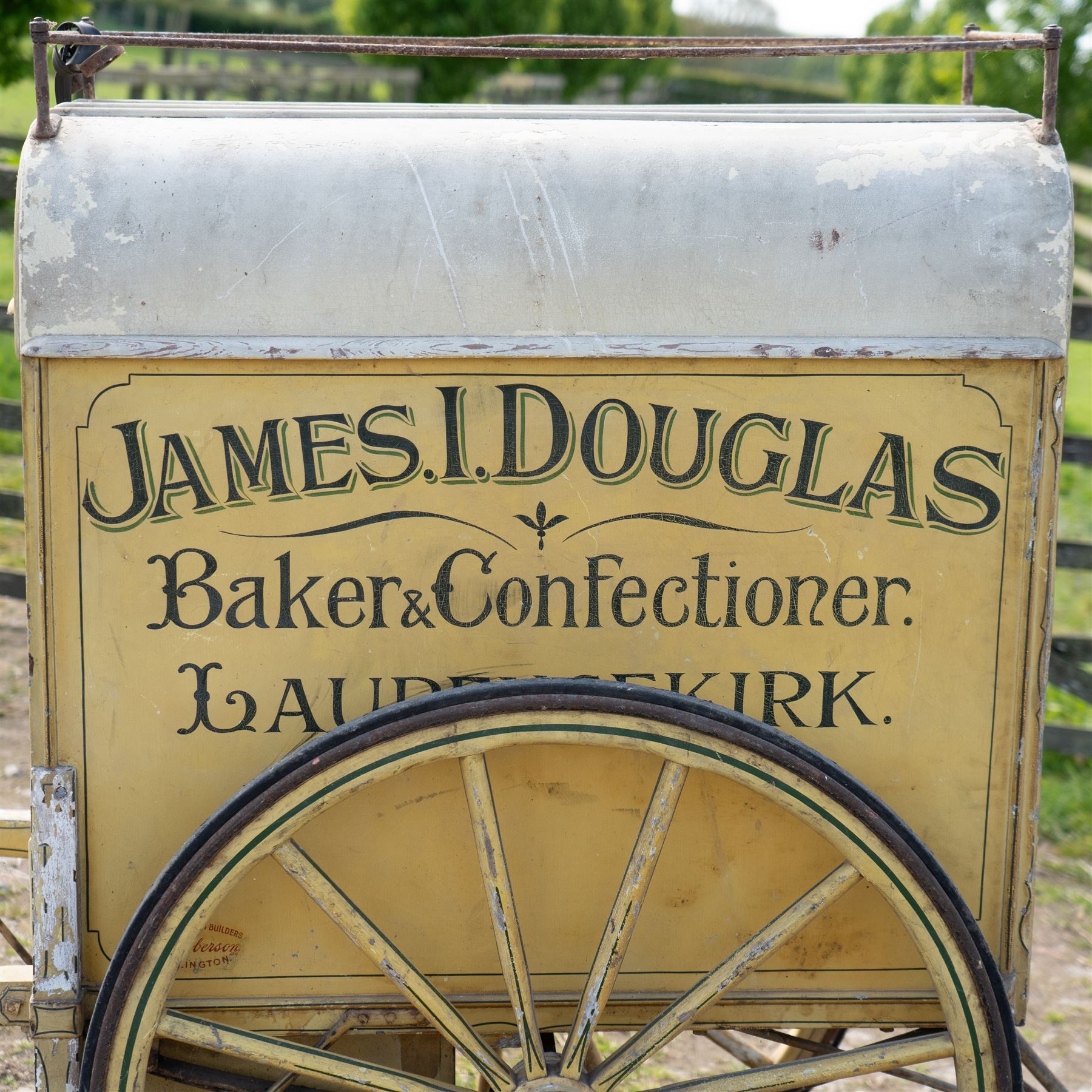 James I. Douglas, Baker & Confectioner, Laurencekirk Hand Drawn Delivery Cart

An attractive late 19th or early 20th century hand drawn baker's delivery cart, finished in cream and retaining its original hand painted advertising livery for James I. Douglas, Baker & Confectioner, Laurencekirk. The enclosed body features a curved roof with external luggage rail, rear access doors and internal shelving for the transport and delivery of bread, cakes and confectionery. Mounted on large wooden spoked wheels with iron tyres and fitted with shaped shafts for a single horse, this is a highly decorative and increasingly scarce example of a provincial tradesman's delivery vehicle, offering excellent display potential for collectors, museums, period interiors or commercial settings.

Features:
• Original hand painted signwriting for James I. Douglas, Baker & Confectioner, Laurencekirk
• Enclosed delivery body with curved roof and external luggage rail
• Rear opening access doors with internal storage compartments
• Original internal wooden shelving and racks
• Large wooden spoked wheels with iron tyres
• Shaped shafts for single horse traction
• Builder's mark for Geo. Roberson Ltd., Wallington
• Decorative cream painted finish with period lining and detailing
• Suitable as a display piece, museum exhibit or advertising feature

Dimensions:
Overall length: 170 cm
Body length: 104 cm
Width: 83 cm
Height: 150 cm

Wheel Diameter:
Wheels: 95 cm