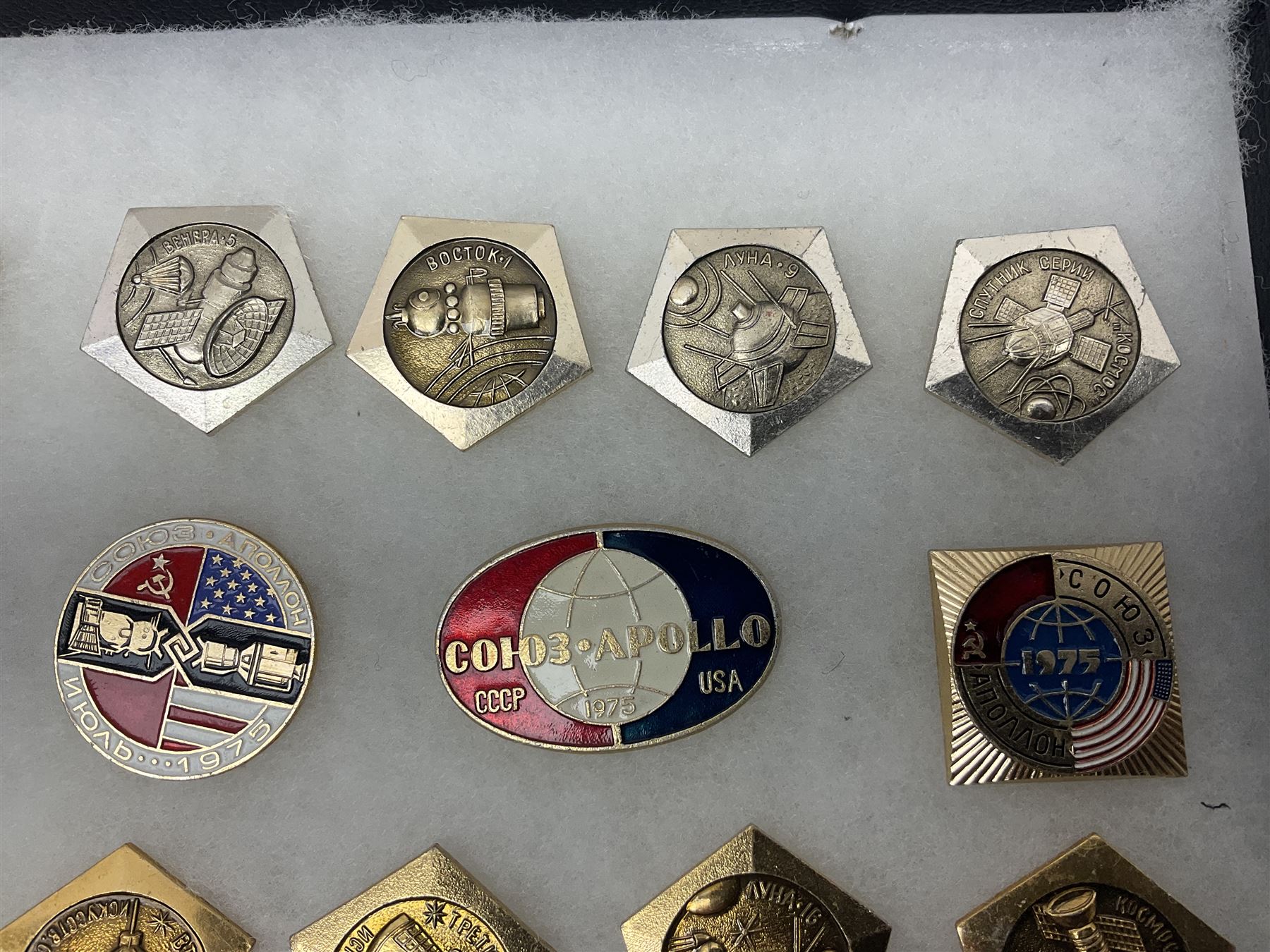 Twenty-six Russian Soviet Space badges 1960s/70s; in small display case