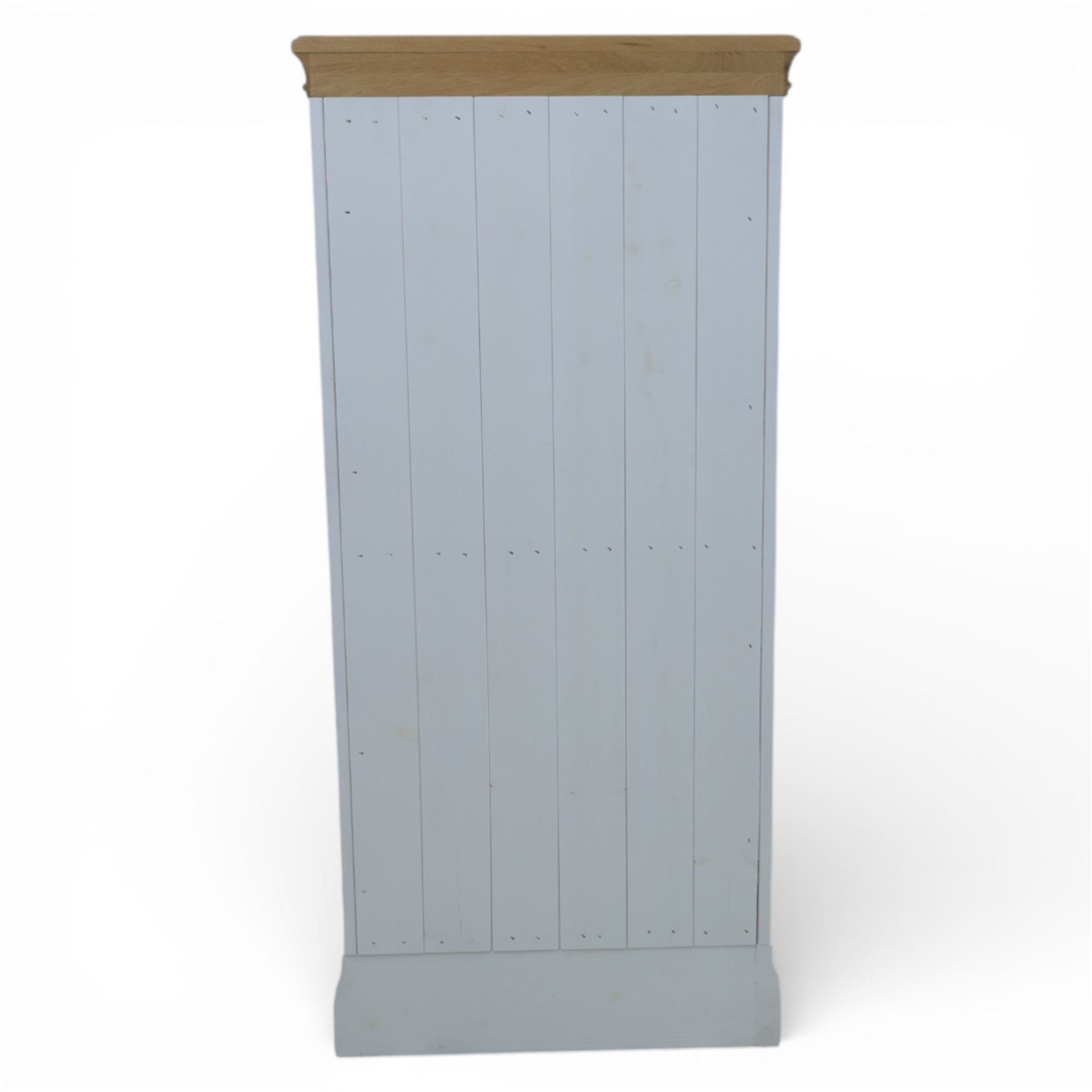 Modern narrow chest of five drawers in white finish with oak moulded top, with metal cup handles raised on a moulded plinth base