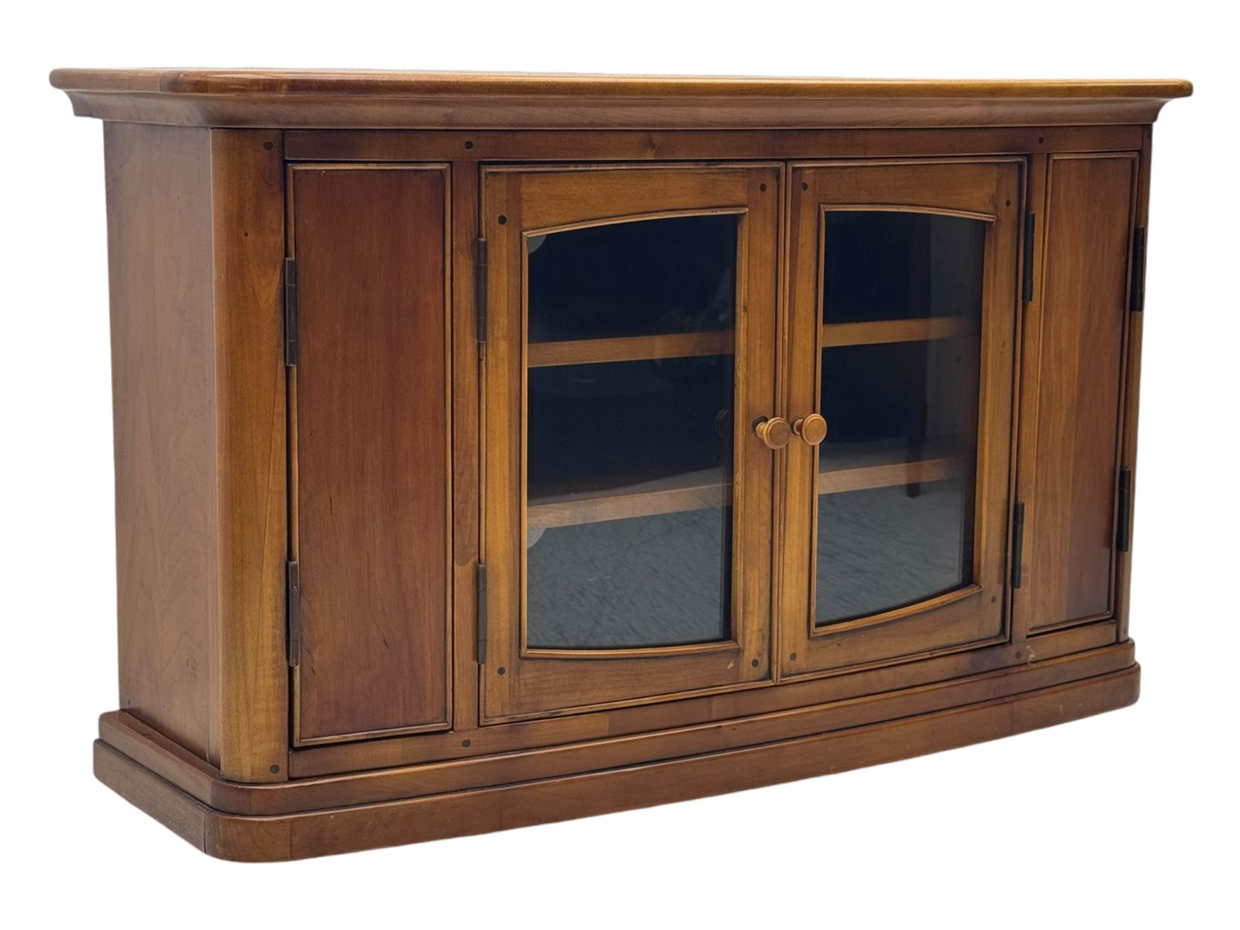 Contemporary cherry wood corner TV unit, canted top over central glazed double doors opening to shelves for media storage, flanked by side storage compartments, on a plinth base