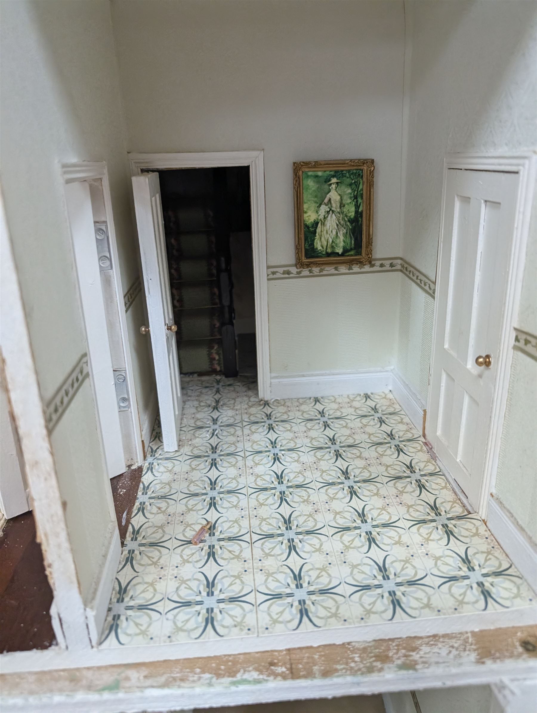 Two modern three storey dolls houses, each painted green with decorated interiors, both upon a single white wooden base, together with a large collection of dolls house furniture, accessories and figures 