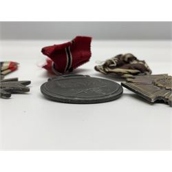 WW2 German Eastern Front Medal awarded to those who served on the German Eastern/Russian Front during the Winter Campaign period of 15th November 1941 to 15th April 1942 with original ribbon; German War Merit Cross with swords; and NSDAP Long Service Award (3)