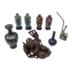 Six cloisonné vases, to include wo pairs of Japanese examples of slender ovoid form ad decorated with blossoming flowers, each approximately H15cm, together with a cloisonné opium pipe, and a Chinese root carving of a recumbent figure with zoomorphic creature, (8)