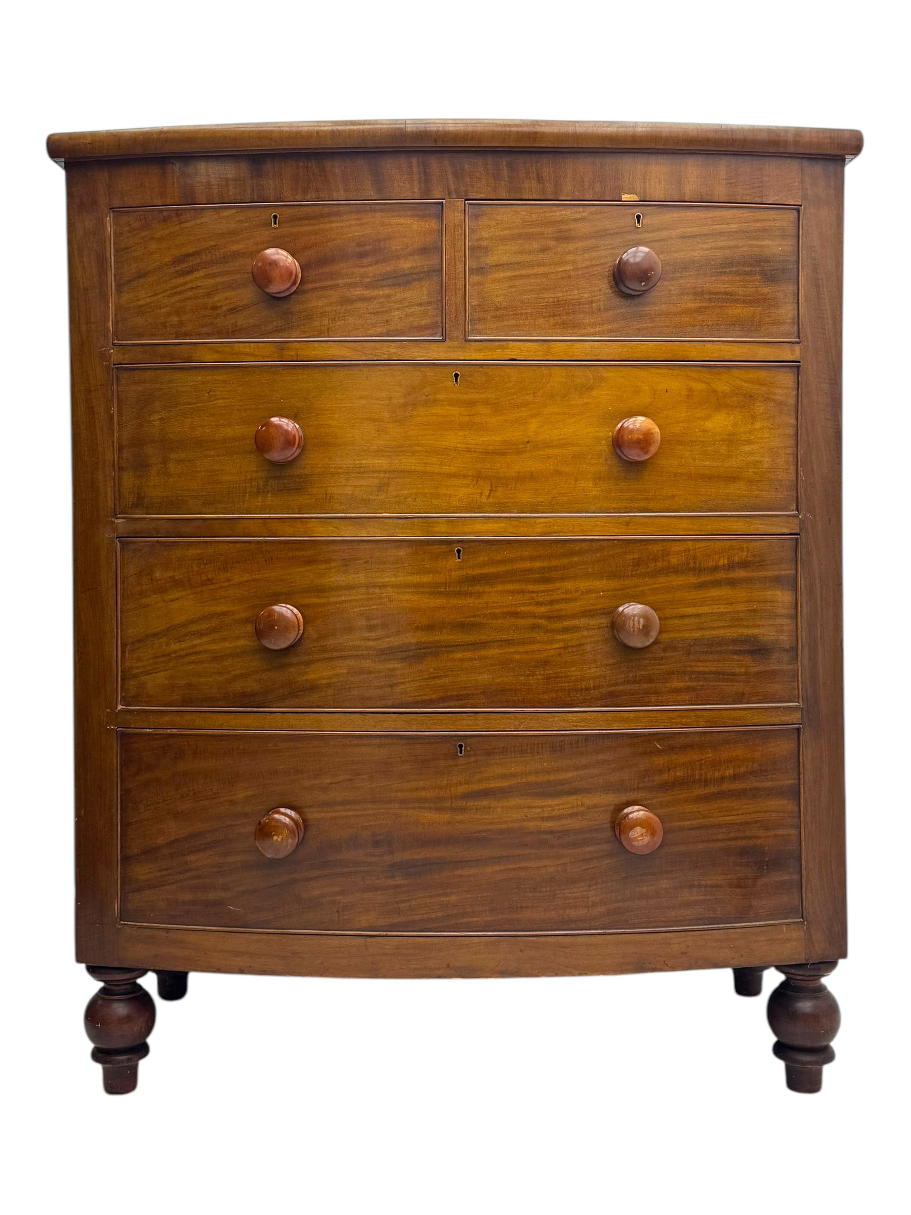 Victorian mahogany bow-fronted chest, fitted with two short over three long graduated cockbeaded drawers, on turned bun supports