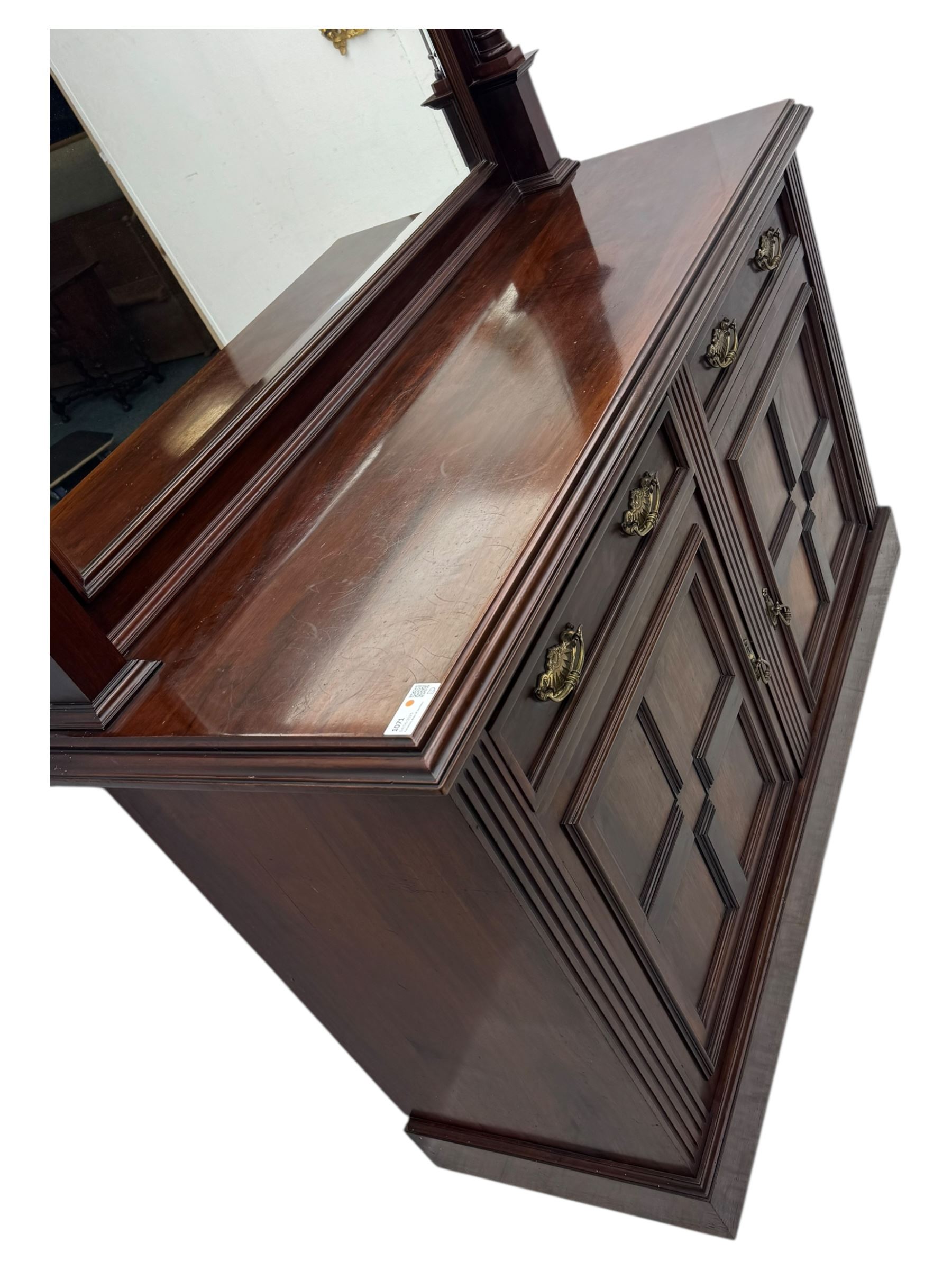 Victorian mirror back press, the arched corniced mirror back flanked by half columns, the base fitted with three drawers and four moulded panel doors with geometric detail, on a block plinth