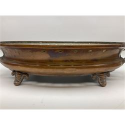 Agricultural copper corn funnel, H32.5cm, another similar copper funnel and copper warming platter of oval form, with twin handles on four supports, with removeable warming plate, L49cm