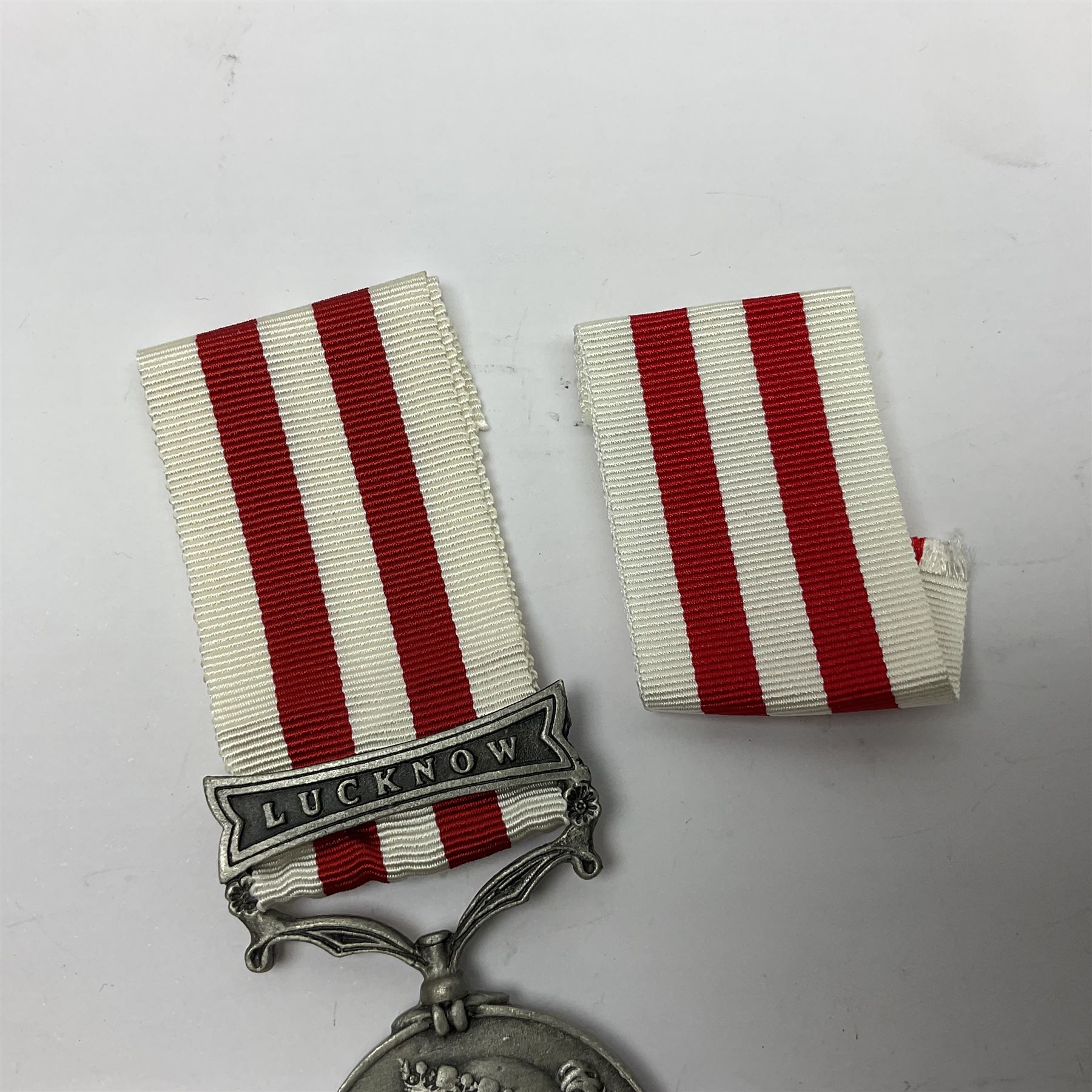 Victoria Long Service in the Volunteer Force Medal awarded to 369 Bombr. W. Woodward 1st Lincs. V.A.; and reproduction Victoria India Medal with Lucknow clasp; both with ribbons (2)