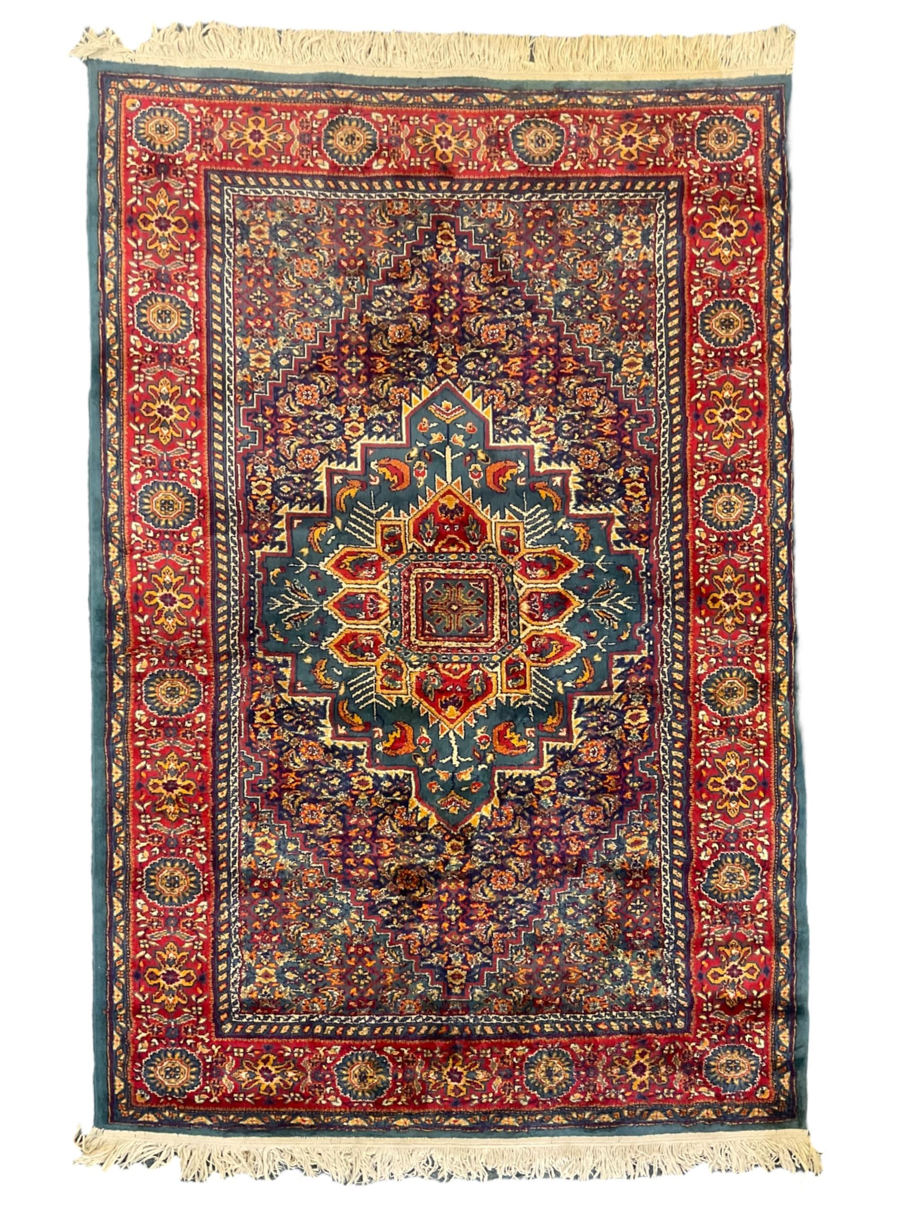 Persian design blue ground rug, the field decorated with Herati motifs and central floral medallion, repeating guarded border decorate with flower heads and trailing leafy branches 