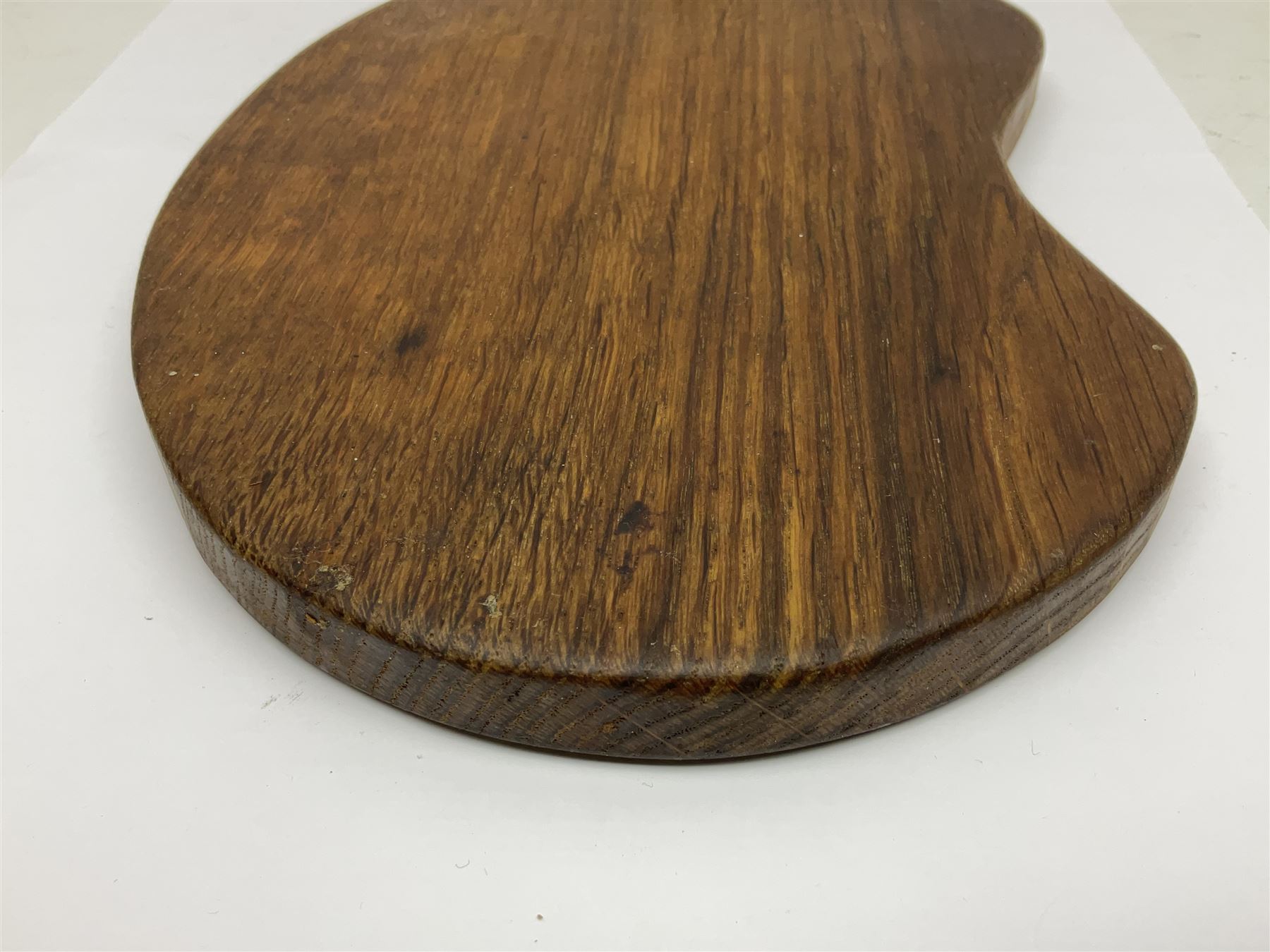 Mouseman - oak kidney-shaped cheeseboard, the handle caved with mouse signature, by the workshop of Robert Thompson, Kilburn 