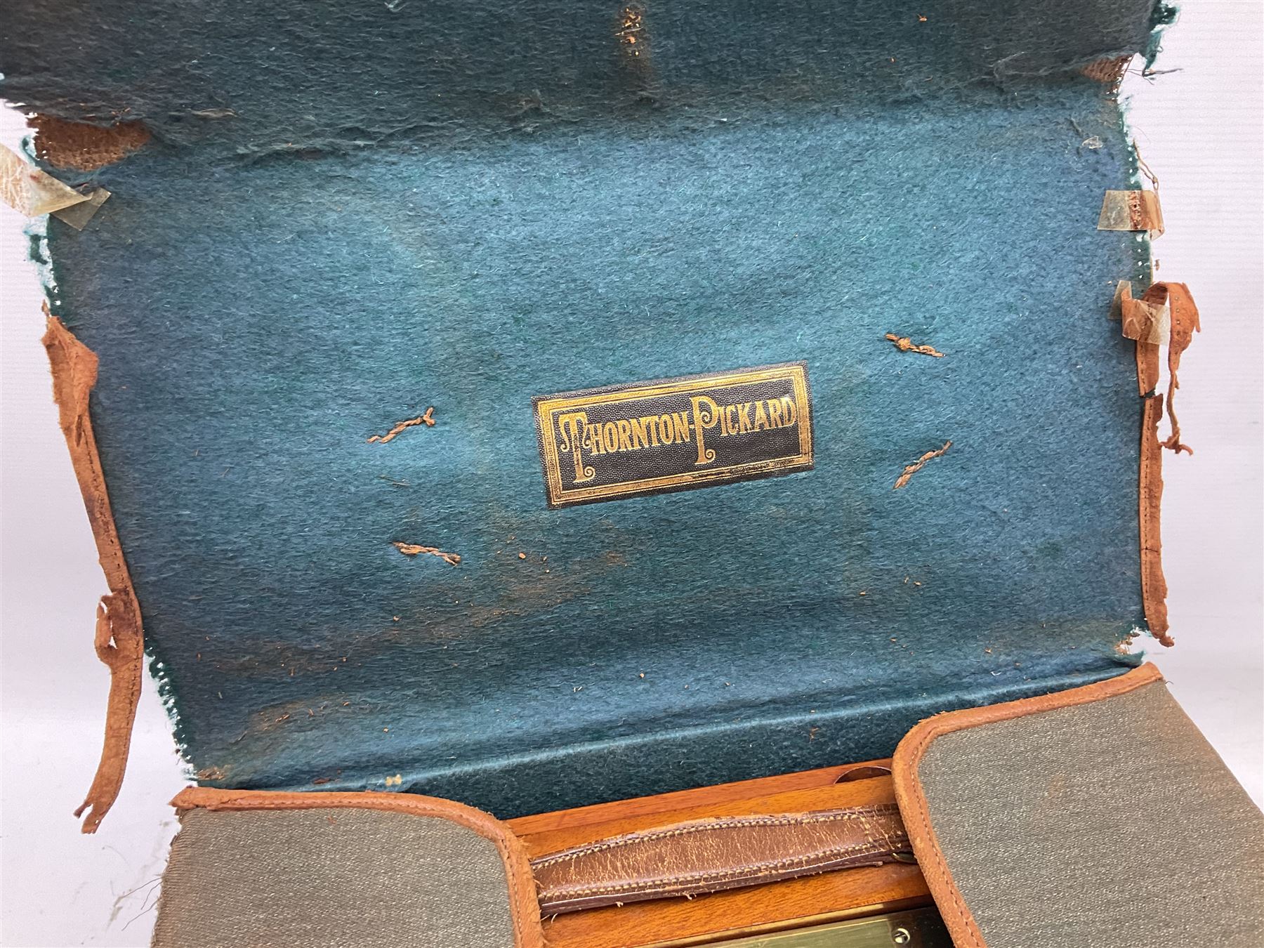 Thornton Pickard folding plate camera in mahogany and lacquered brass, no.529946 and no.529947, field model with canvas wrapped box, three mahogany photographic plates, 'Busch's Portrait Aplanat No4 Foc.14inc' lens and a wooden tripod